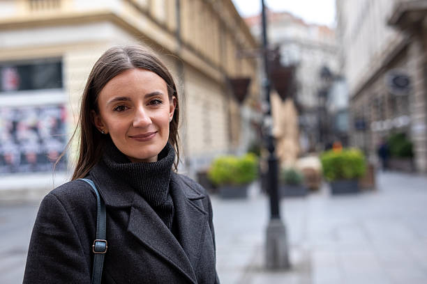 files/young-adult-woman-standing-on-european-city-street-smiling-stock-photo.png